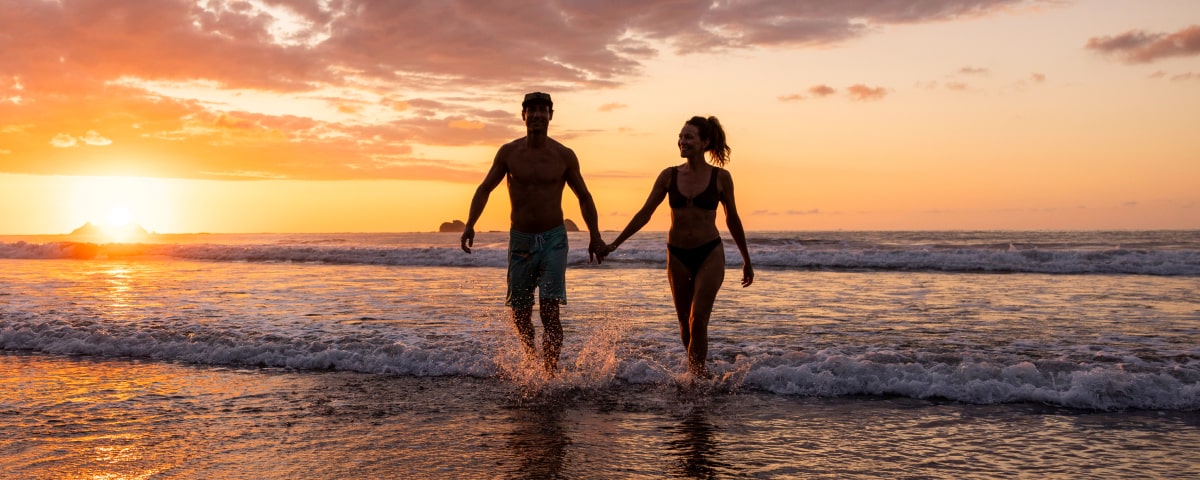 Couple walking on beach-Fall Promo Image